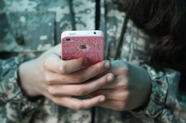 A student from the General Yermolov Cadet School plays with her mobile phone during a two-day field exercise near the village of Sengileyevskoye